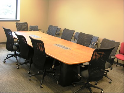 An empty conference room table in BME 4.202H with 10 chairs and chairs placed against the wall