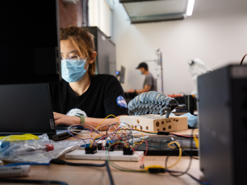 Texas Biomedical engineering student working on prototype next to computer