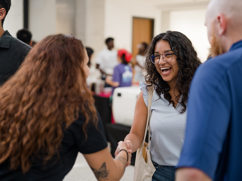 Texas Biomedical Engineering student shaking hands with industry professional