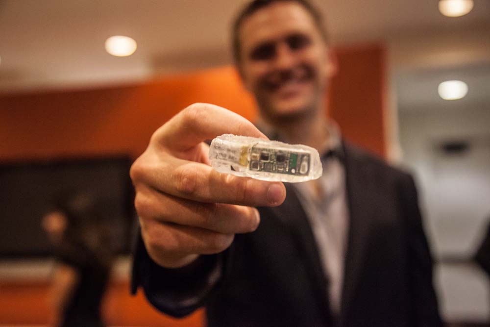 Texas BME student holding small capstone project prototype