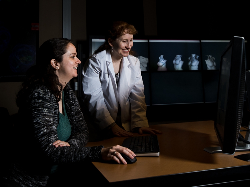 Texas engineering professor Mia Markey looking at computer with graduate student