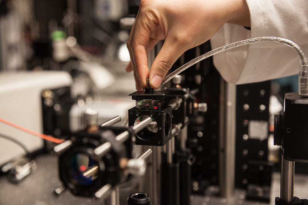 Hand of BME student using lab equipment for imaging research