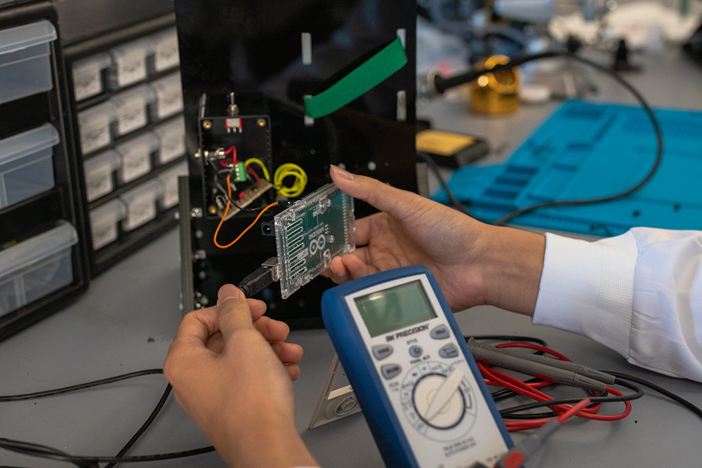 Hands using a piece of electronic equipment in the BME lab