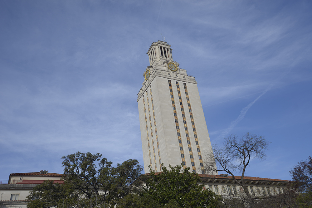 UT Tower from below with blue sky in the background