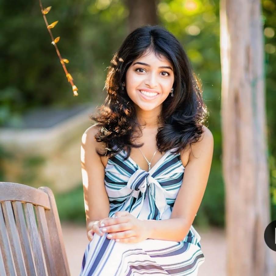 Aditi Merchant sitting and smiling for portrait