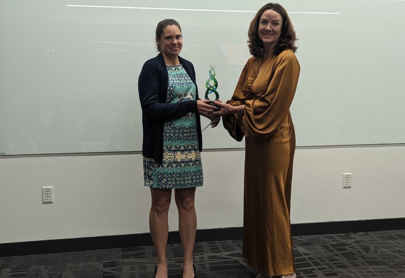 Professor Laura Suggs and A.J. Welch's granddaughter standing together holding award