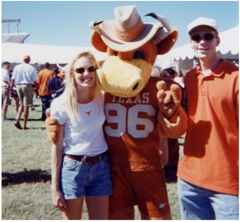 Nichole and Chris Rylander smiling with Hook 'Em mascot at tailgate