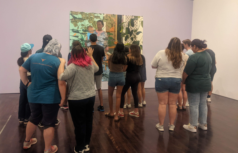 Onlookers gathered around a piece of art in museum