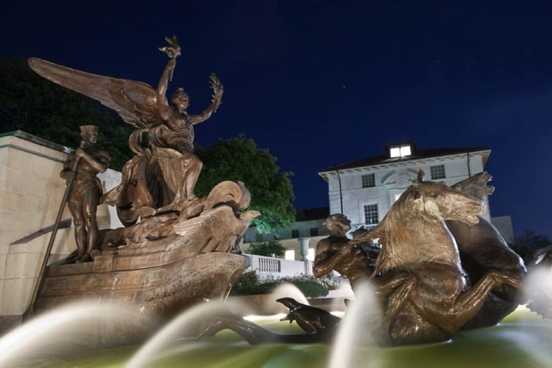 A view of a fountain on the UT Austin Campus at night