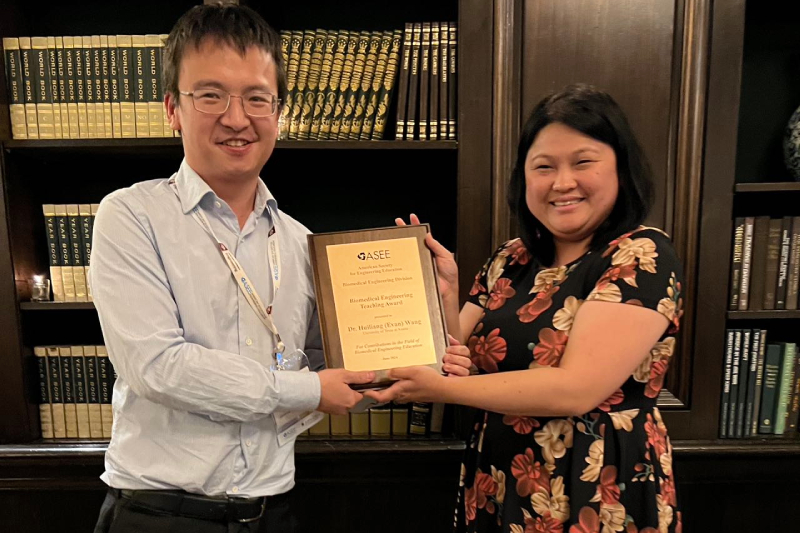 UT Austin Department of Biomedical Engineering professor Evan Wang holds his ASEE Award.