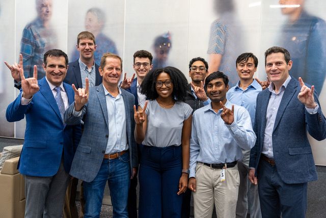 the Tunnell CID team giving the hook 'em hand gesture