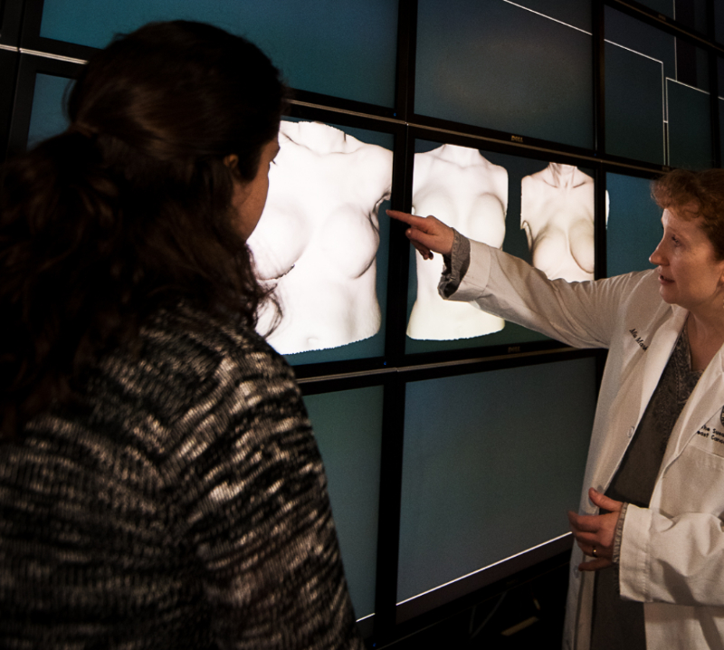 Texas Engineer Mia Markey gesturing towards x-rays on display