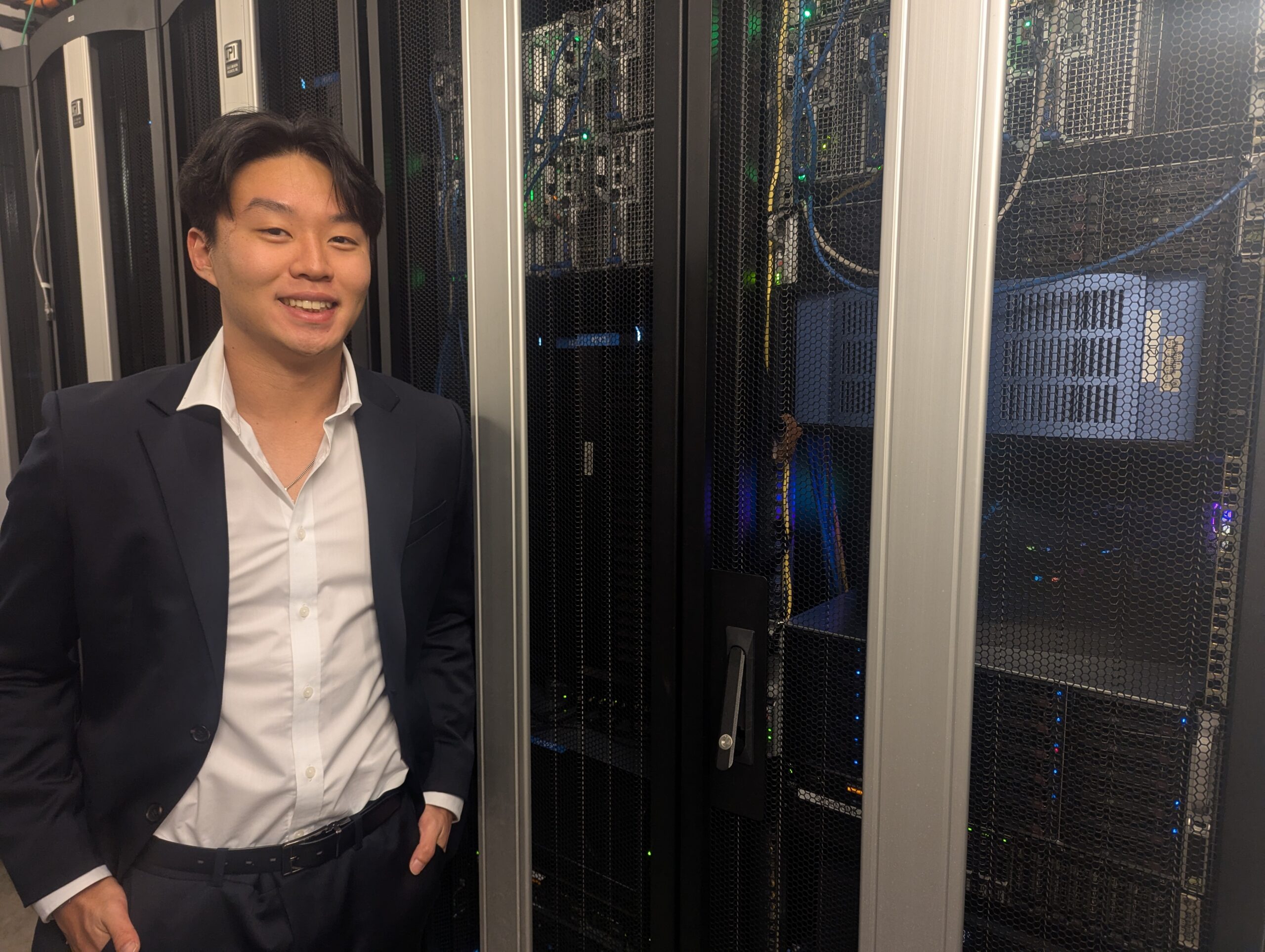 Jeongwook Luke Yun stands in front of computer servers