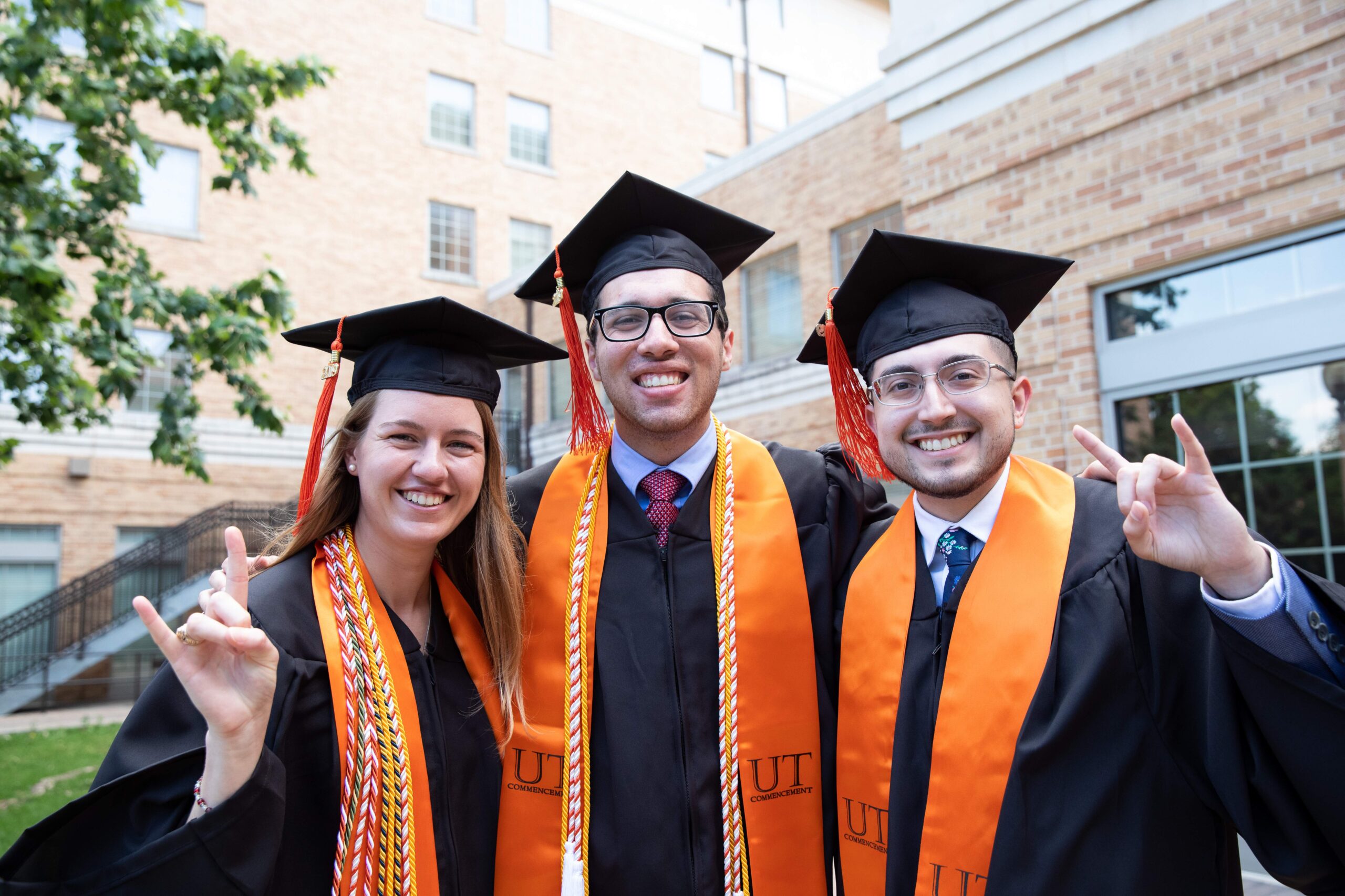 Three graduates in graduation gowns 