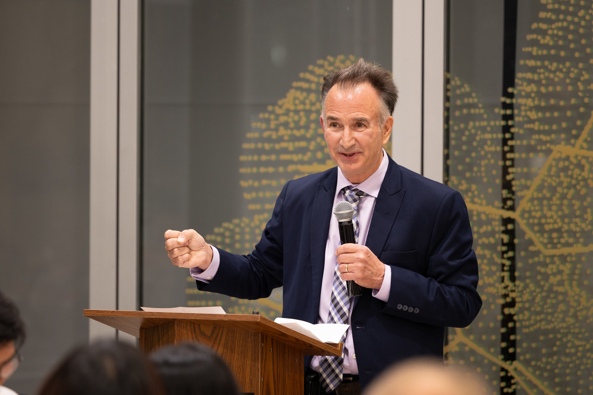 Thomas Milner speaking at podium