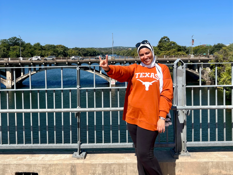Texas BME student Alaa Melek standing on Austin city bridge