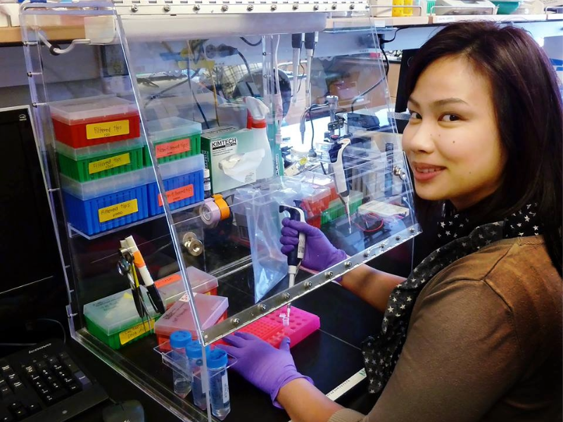 Nuttada Panpradist smiling at camera while working in a lab