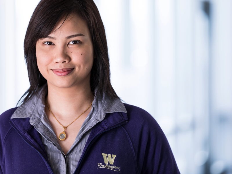 Nuttada Panpradist smiling and wearing University of Washington sweatshirt