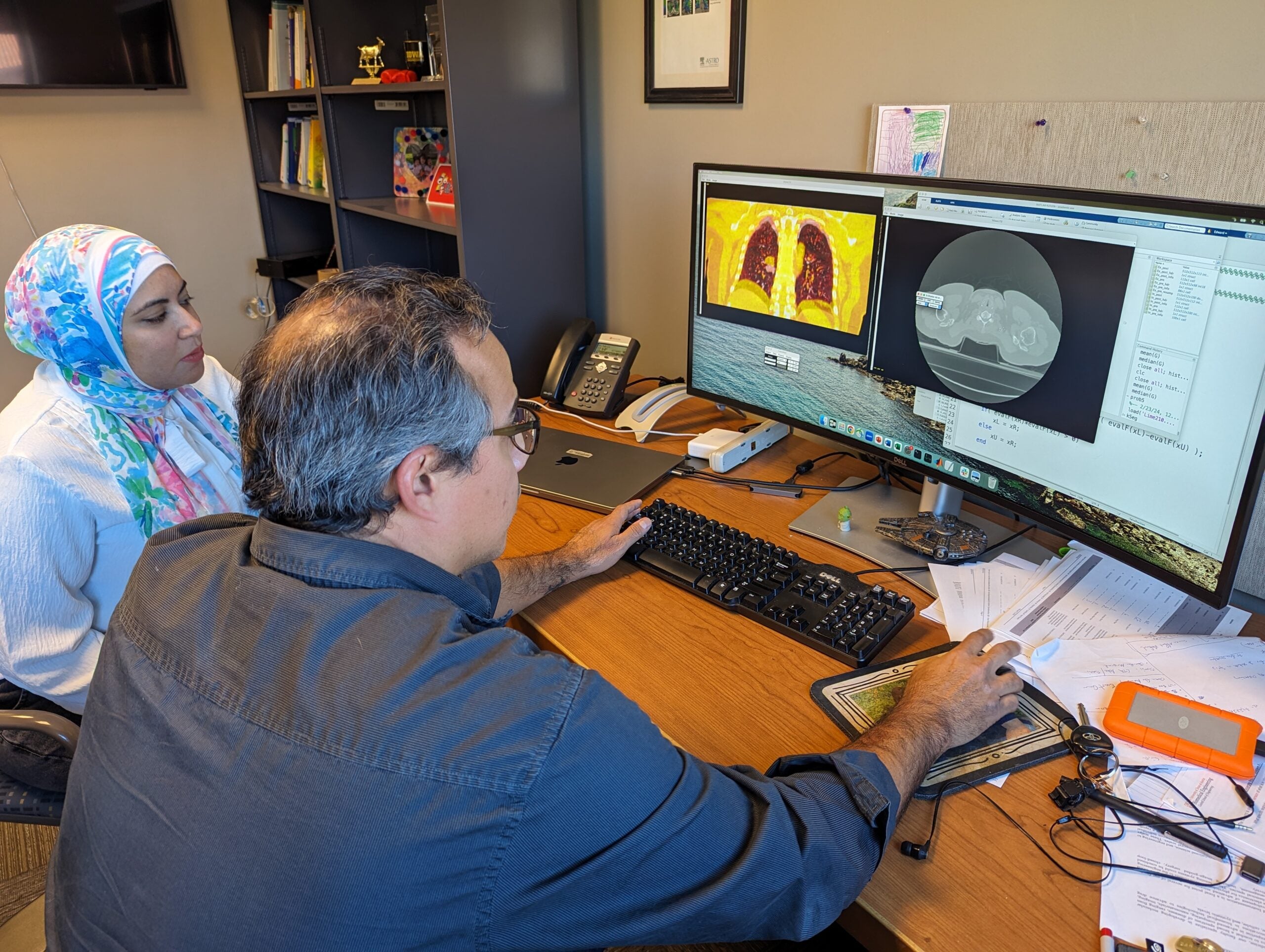 Texas BME student Alaa Melek and professor Edward Castillo working at a computer