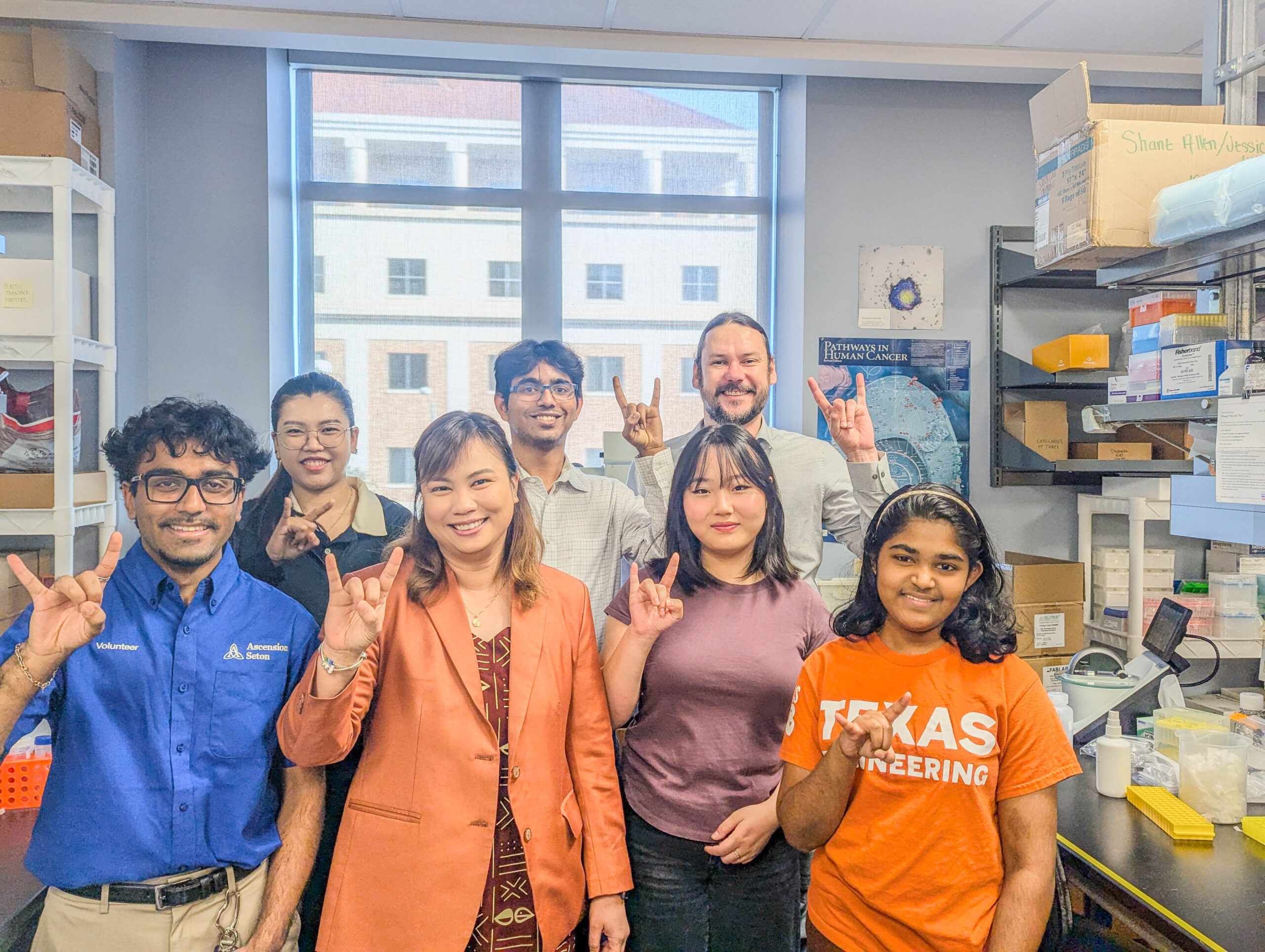 Texas Engineer Nuttada Panpradist smiling in her lab with students