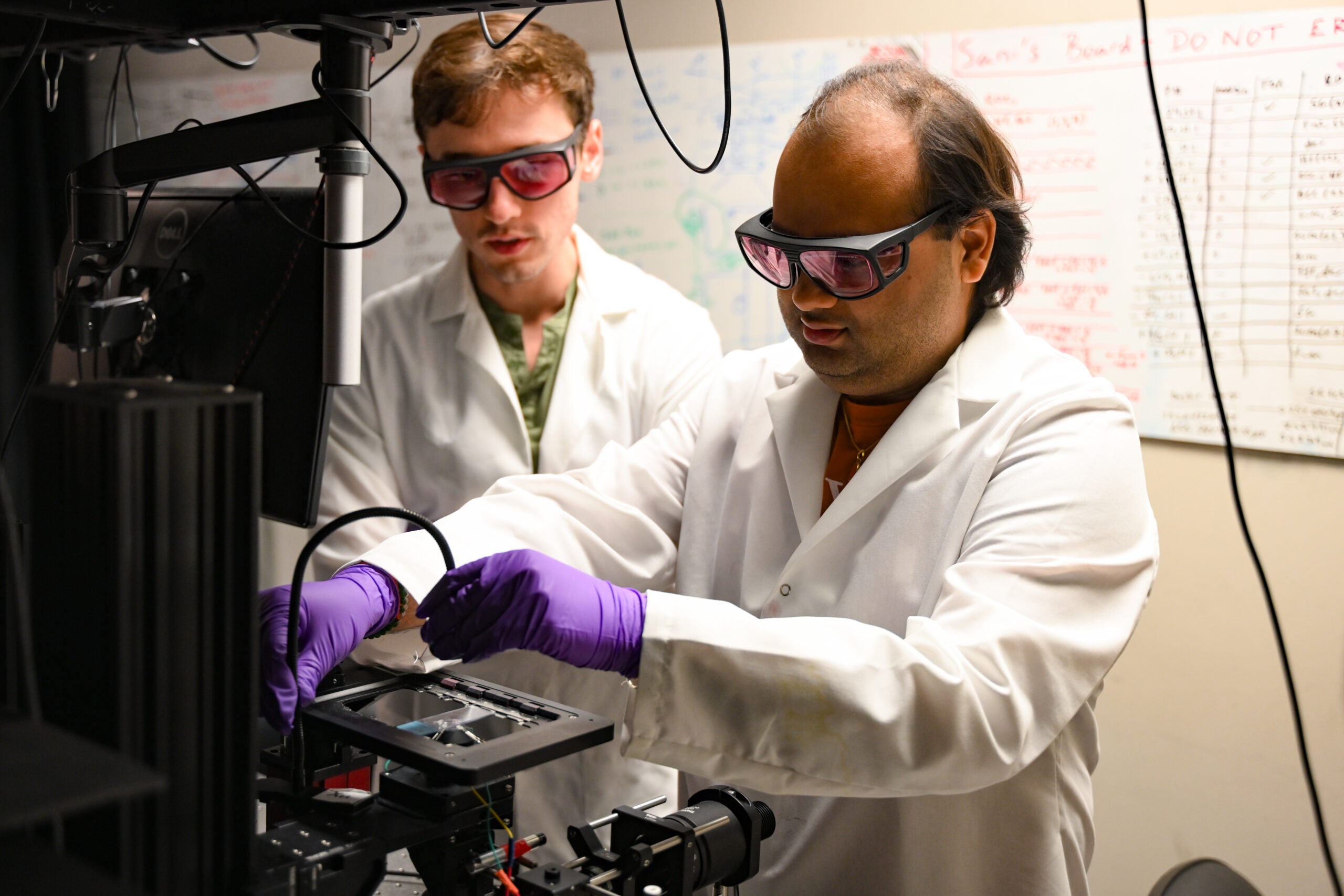 UT grad students performing imaging work in James Tunnell lab