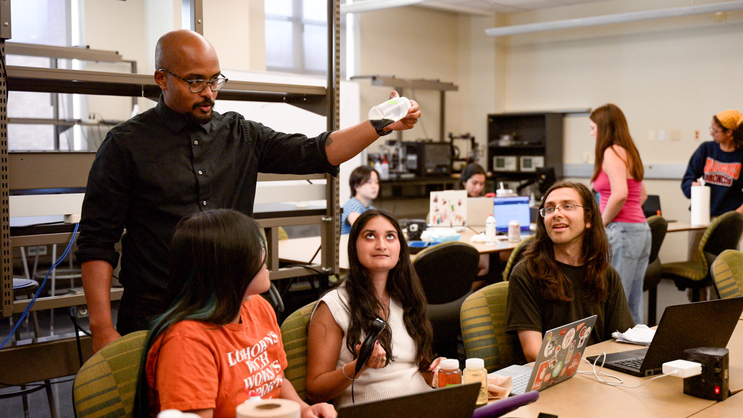 Adam Bush hands on learning with students