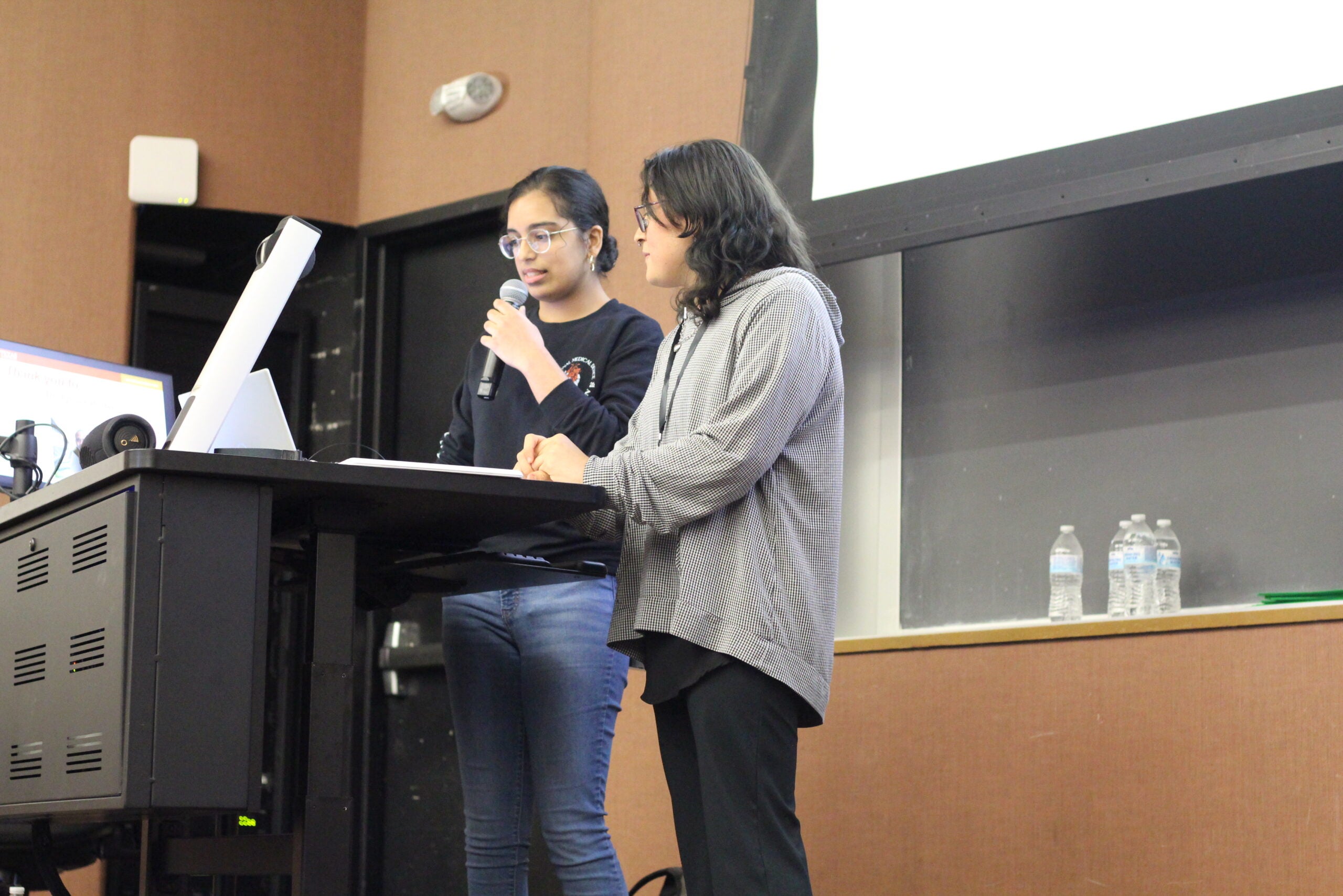 UT BME students Amrita Amrora and Aethyr Villela presenting at event