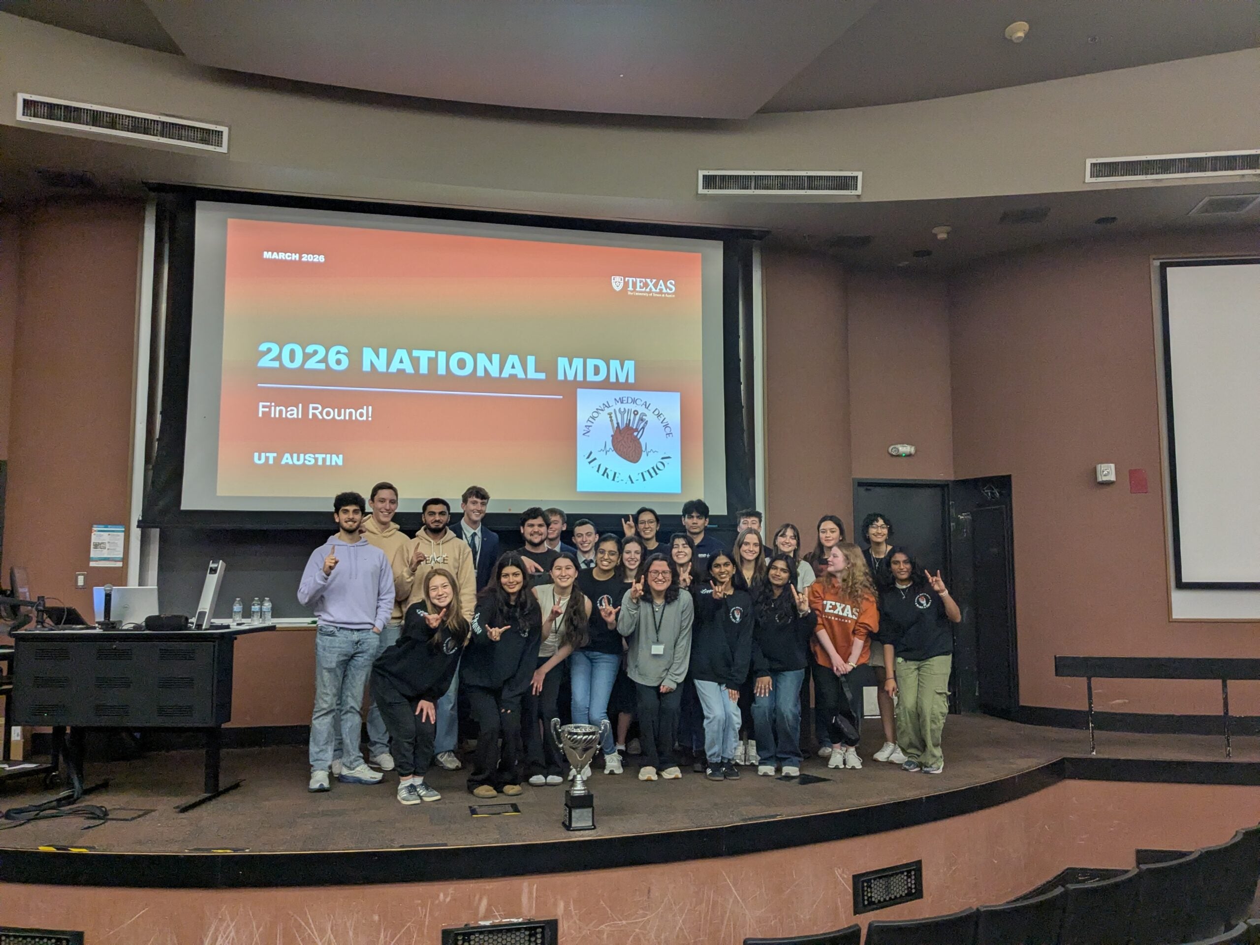 Students pose in front of screen at 2026 Medical Device Makaeathon